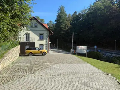 a yellow car parked in front of a house at Mulino Apartments