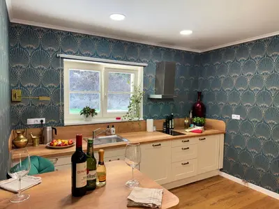 a kitchen with a table with wine glasses on it at Mulino Apartments