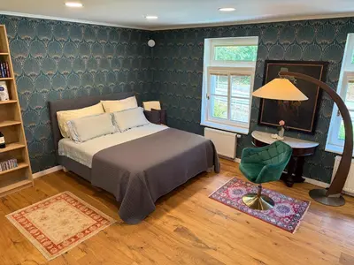 a bedroom with a bed and a table and a window at Mulino Apartments