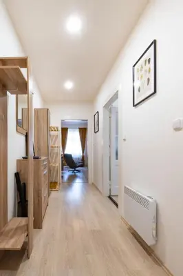 a hallway with white walls and wooden floors at Cozy Apartment near The Old Town Square in Prague