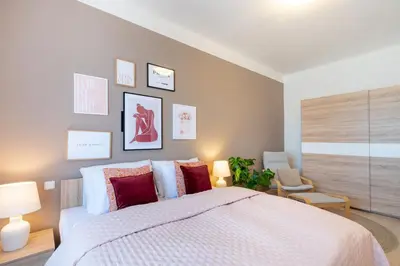 a bedroom with a large white bed with red pillows at Cozy Apartment near The Old Town Square in Prague