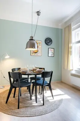 a dining room with a black table and chairs at Cozy Apartment near The Old Town Square in Prague