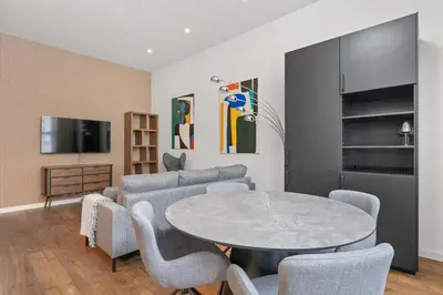 a living room with a table and chairs at Design Apartment in the heart of Old Town Prague in Prague