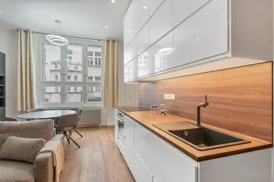 a kitchen with a sink and a table and a window at Design Apartment in the heart of Old Town Prague in Prague
