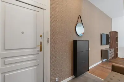 a hallway with a door and a mirror at Design Apartment in the heart of Old Town Prague in Prague