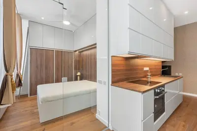 a kitchen with white cabinets and a sink at Design Apartment in the heart of Old Town Prague in Prague