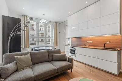a living room with a couch and a kitchen at Design Apartment in the heart of Old Town Prague in Prague