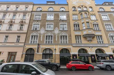 a large building with cars parked in front of it at Design Apartment in the heart of Old Town Prague in Prague