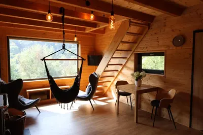 a room with a hammock in a log cabin at Chata Cedrus in Hradištko