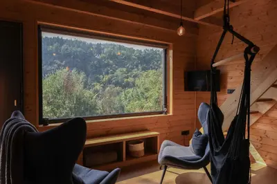 a room with chairs and a window in a cabin at Chata Cedrus in Hradištko