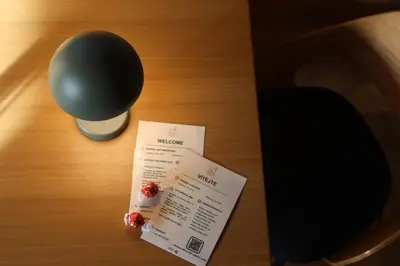 a table with a ticket and a lamp on it at Chata Cedrus in Hradištko