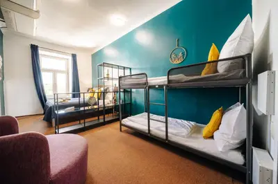 a room with two bunk beds and a couch at Smichov MixHause Residence by Wagnerstays in Prague