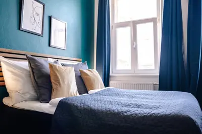 a bedroom with blue walls and a bed with pillows at Smichov MixHause Residence by Wagnerstays in Prague