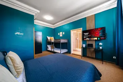a blue bedroom with a bed and a flat screen tv at Smichov MixHause Residence by Wagnerstays in Prague
