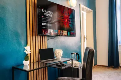 a room with a desk with a laptop on it at Smichov MixHause Residence by Wagnerstays in Prague