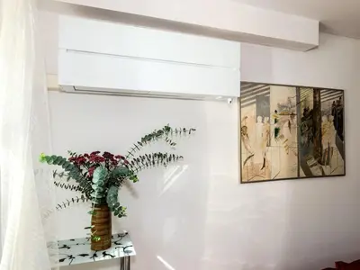 a plant in a vase on a shelf in a room at Apartment Hanspaulka - Stylish, Parking Included, 15 min Airport in Prague