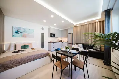 a bedroom with a bed and a table with chairs at Prague Days - Studio near Vyšehrad with Netflix and 250Mbs WiFi in Nusle in Prague