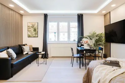 a living room with a couch and a table at Prague Days - Studio near Vyšehrad with Netflix and 250Mbs WiFi in Nusle in Prague