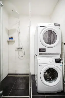 a washing machine in a bathroom with a shower at Prague Days - Studio near Vyšehrad with Netflix and 250Mbs WiFi in Nusle in Prague