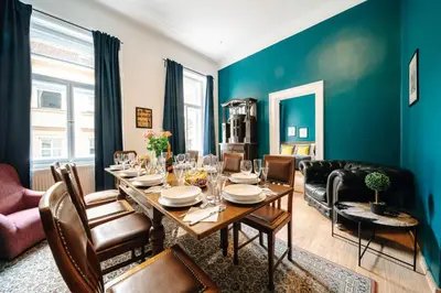 a dining room with a table and a couch at Bohemia Grand Residence by Wagnerstays in Prague