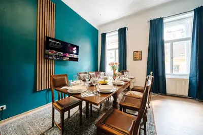 a dining room with a long table and chairs at Bohemia Grand Residence by Wagnerstays in Prague