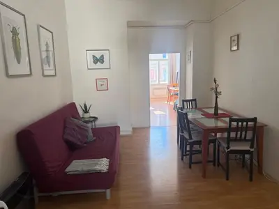 a living room with a red couch and a table at Johan apartments in old Vinohrady in Prague