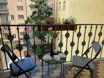 a balcony with a table and chairs on a balcony at Johan apartments in old Vinohrady in Prague