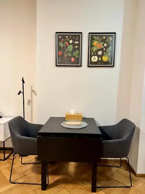 a kitchen with a table and a stove and a counter at Apartmán U Smaltovny 27 in Prague