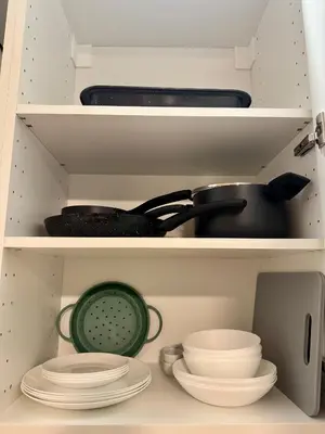 a shelf with cups and wine glasses in a kitchen at Apartmán U Smaltovny 27 in Prague
