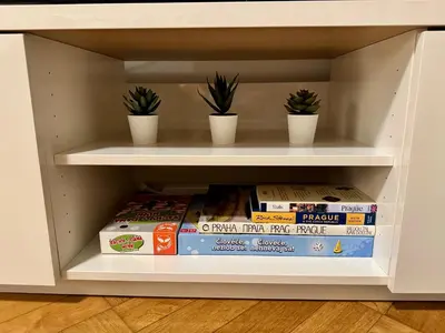 a white entertainment center with a flat screen tv on it at Apartmán U Smaltovny 27 in Prague