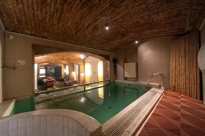 a swimming pool in a building with a large room at Party ClubHouse with Bar, Panoramic Pool & Sauna in Prague
