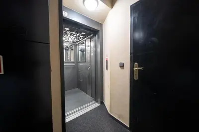 a hallway with a black door and a door at Party ClubHouse with Bar, Panoramic Pool & Sauna in Prague