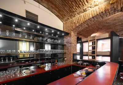 a kitchen with a bar with glasses on the shelves at Party ClubHouse with Bar, Panoramic Pool & Sauna in Prague