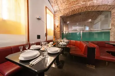 a dining room with a table and red chairs at Party ClubHouse with Bar, Panoramic Pool & Sauna in Prague