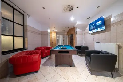 a room with a pool table and couches and a tv at Party ClubHouse with Bar, Panoramic Pool & Sauna in Prague