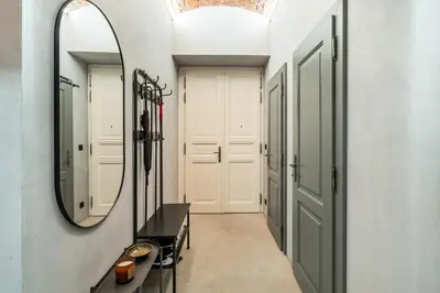 a hallway with a large mirror and a table at Dream Luxury Studio Prague DS1 in Prague
