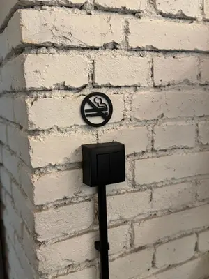 a no smoking sign on a brick wall at Dream Luxury Studio Prague DS1 in Prague