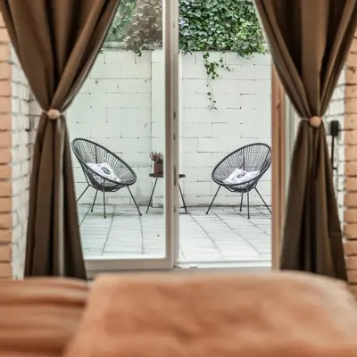 two chairs sitting on a patio looking out the window at Dream Luxury Studio Prague DS1 in Prague