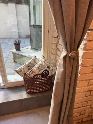 a basket of pillows sitting on a window sill at Dream Luxury Studio Prague DS1 in Prague