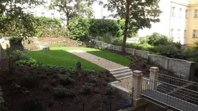 a small garden with a yard of green grass at Get Prague Flat Slovenska in Prague