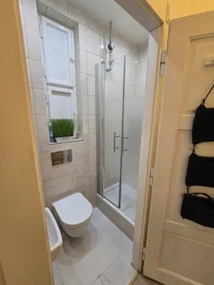 a bathroom with a shower with a tub at Get Prague Flat Slovenska in Prague
