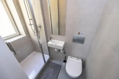 a small bathroom with a toilet and a sink at Apartments Rehorova 30 in Prague