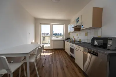 a small kitchen with a table and a microwave at Apartments Rehorova 30 in Prague