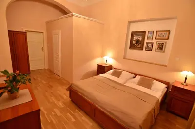 a bedroom with a large bed and two night stands at Pension Karlova in Prague