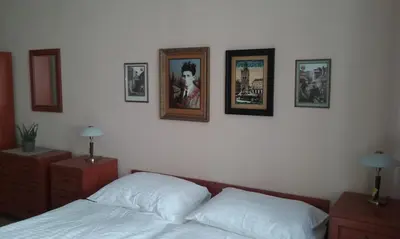 a bedroom with a bed and pictures on the wall at Pension Karlova in Prague