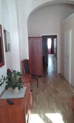a living room with a table and a chair at Pension Karlova in Prague