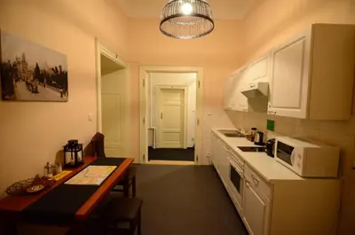 a small kitchen with a table and a microwave at Pension Karlova in Prague