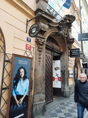 a man walking down a street in front of a store at Pension Karlova in Prague