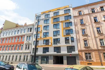 a large building with cars parked in front of it at Brand new studio apartment #50 FREE PARKING close to center in Prague