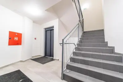 a staircase in a building with a red door at Brand new studio apartment #50 FREE PARKING close to center in Prague